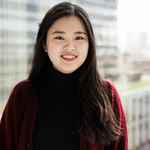 Student smiling, dark hair, red shirt